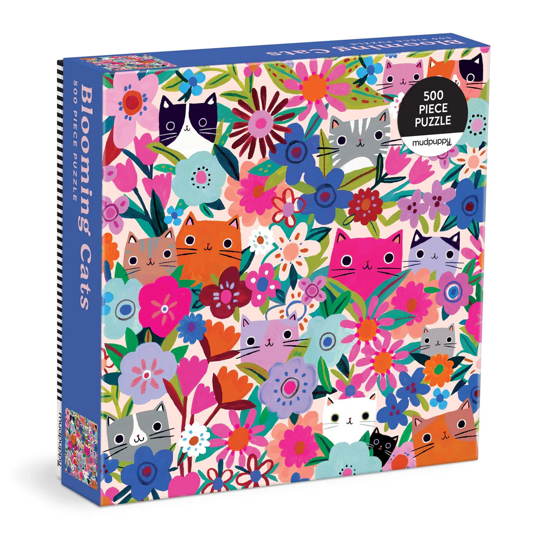 Blooming Cats 500-piece puzzle featuring illustrated cats surrounded by and blended with colorful blooming flowers in a whimsical art style.