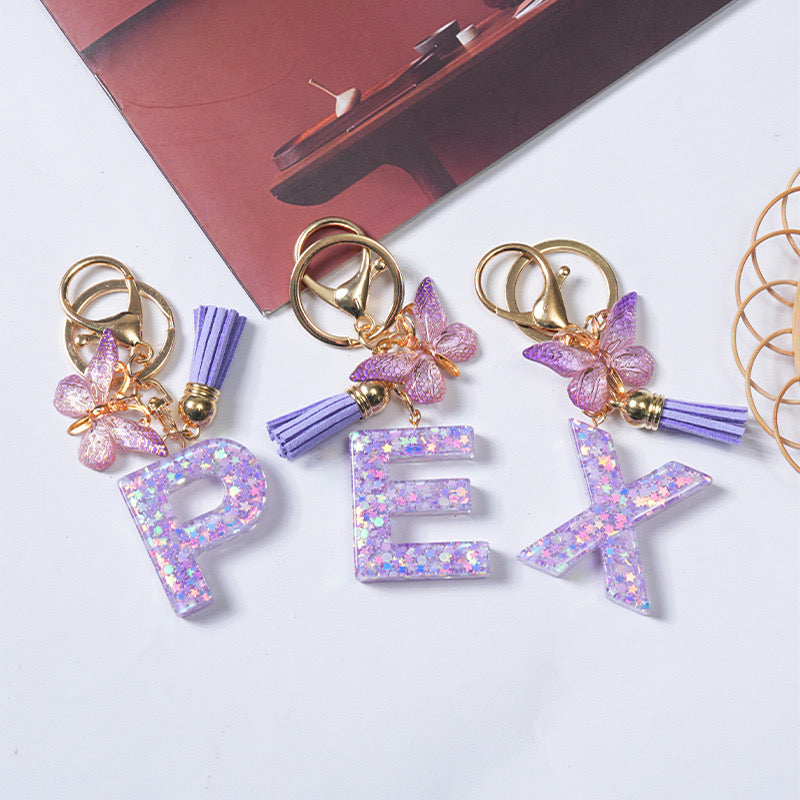Purple Glitter Resin Initial Keychain – Butterfly & Tassel Charm Gift