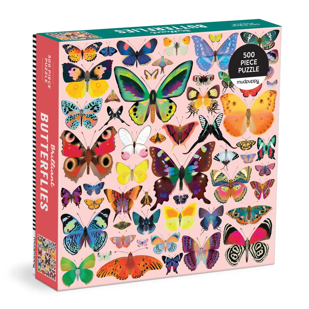 Brilliant Butterflies 500-piece puzzle featuring a symmetrical arrangement of colorful illustrated butterflies on a light background.