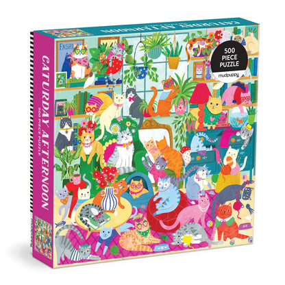 Caturday Afternoon 500-piece puzzle by Mudpuppy featuring a colorful scene of fashionable cats lounging in a cozy room filled with plants and décor.
