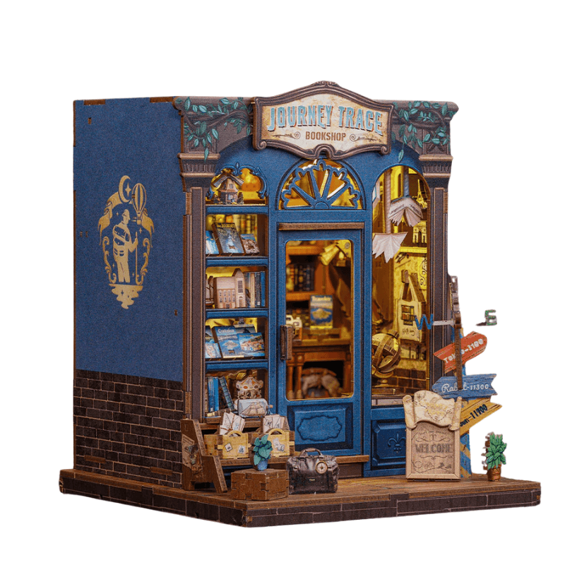 Journey Trace Bookshop DIY book nook kit – blue travel-themed miniature bookstore with vintage suitcases, books, and adventure details