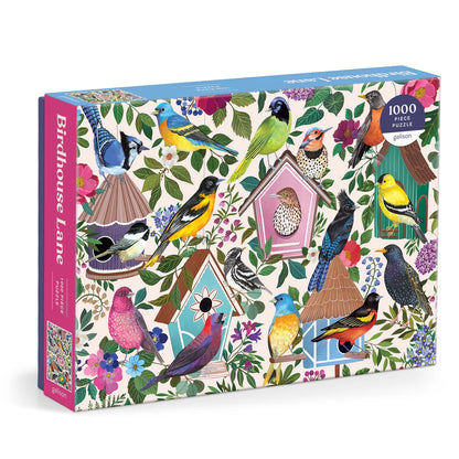 Birdhouse Lane 1000-piece puzzle featuring a charming illustrated scene of a garden path lined with birdhouses, flowers, trees, and colorful birds.