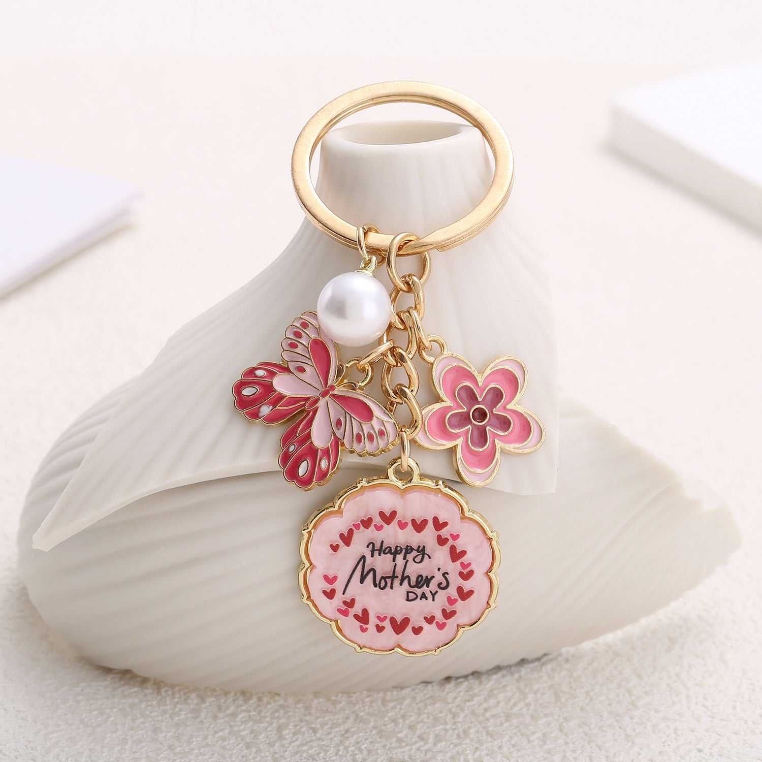 Mother’s Day floral keychain with butterfly, pink flower, and pearl charm – gold-tone design