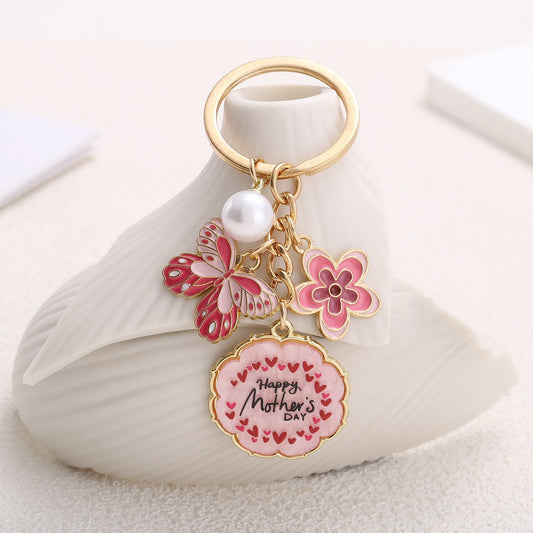 Mother’s Day floral keychain with butterfly, pink flower, and pearl charm – gold-tone design